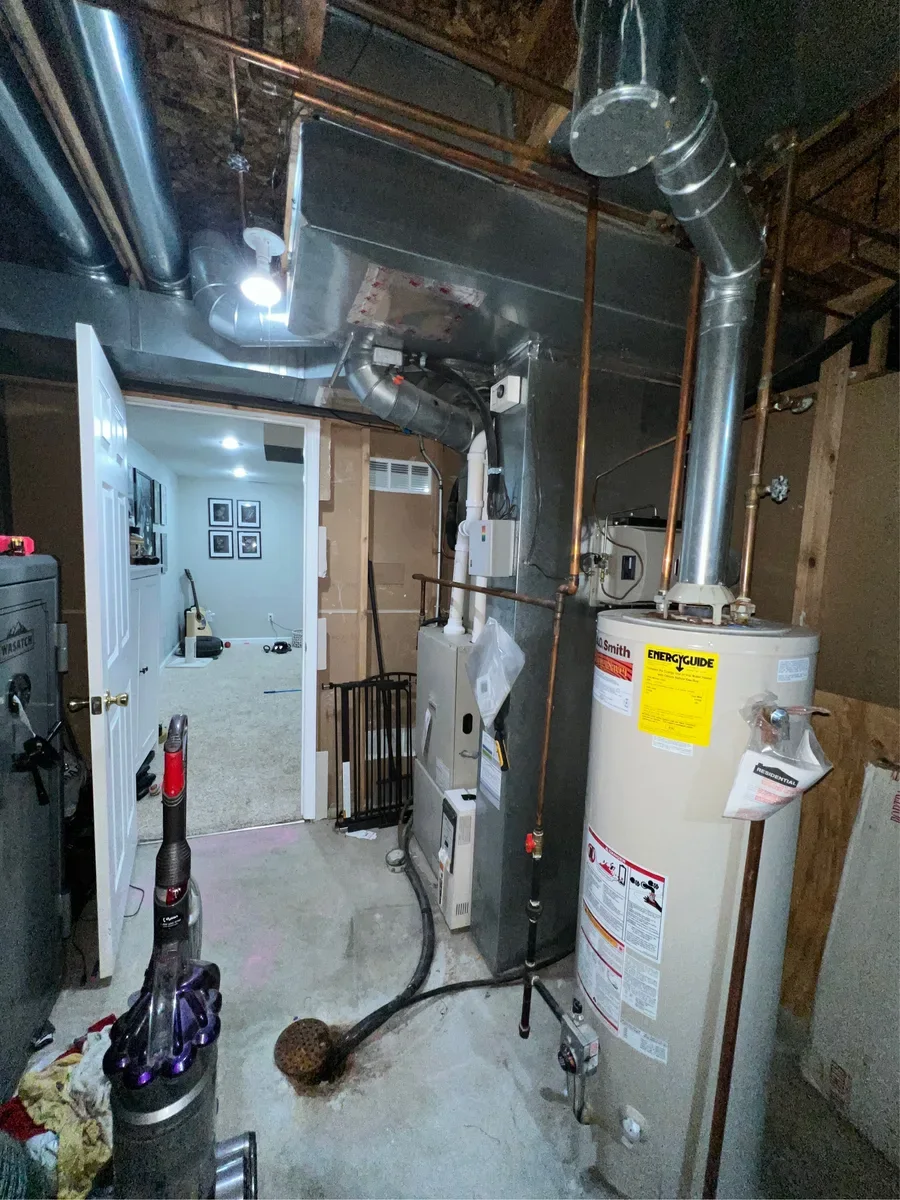 Existing furnace beside the water heater before replacement in Lake St. Louis.