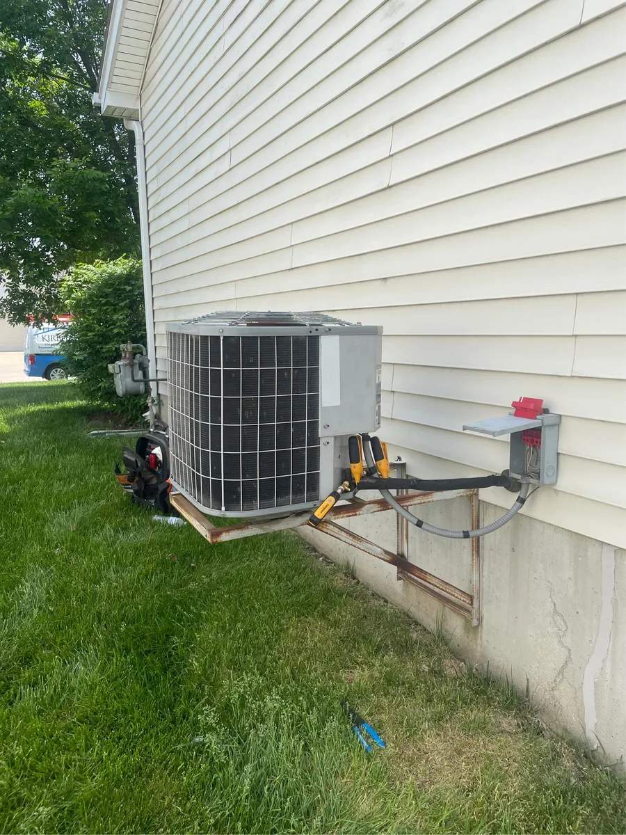 Original air conditioner and service connections before replacement in St. Charles.