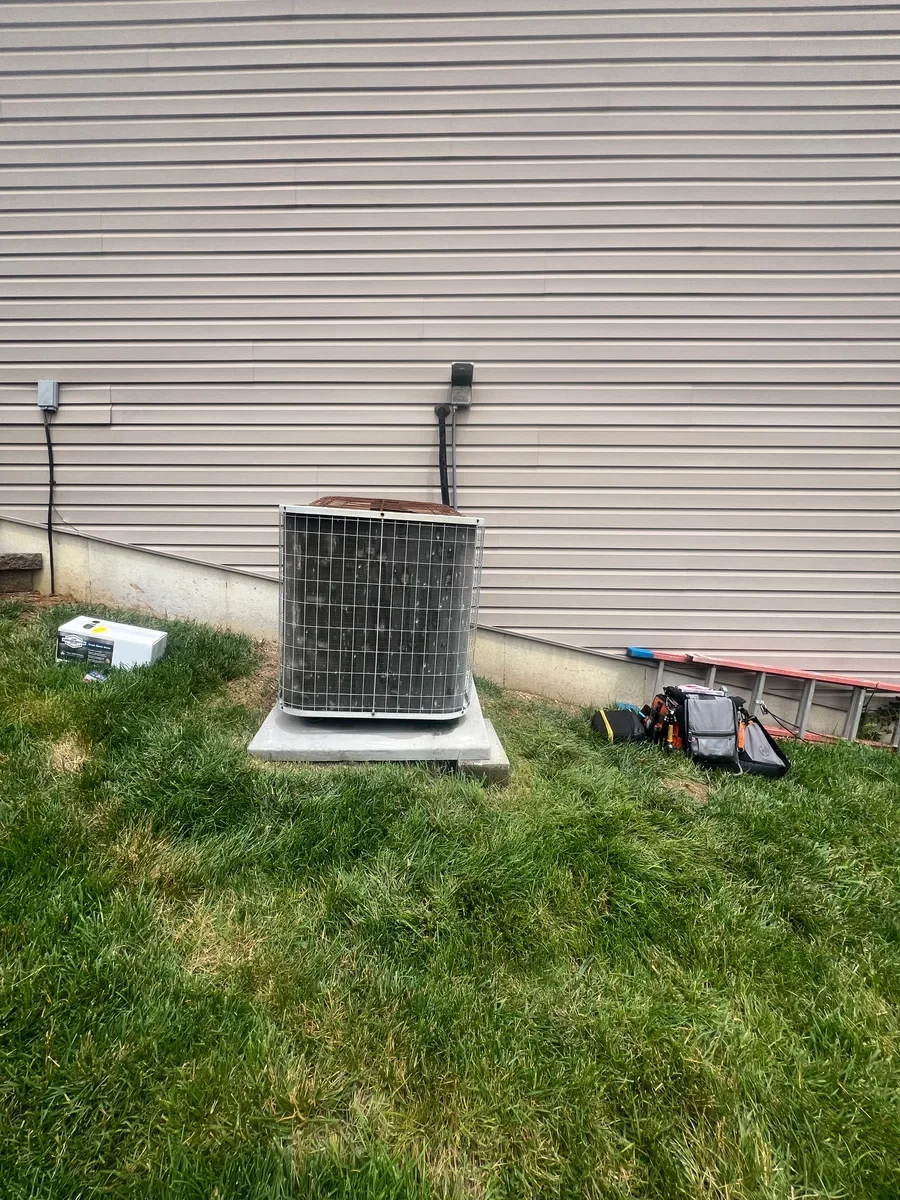 Original air conditioner with the nearby service lines before replacement in Wentzville.