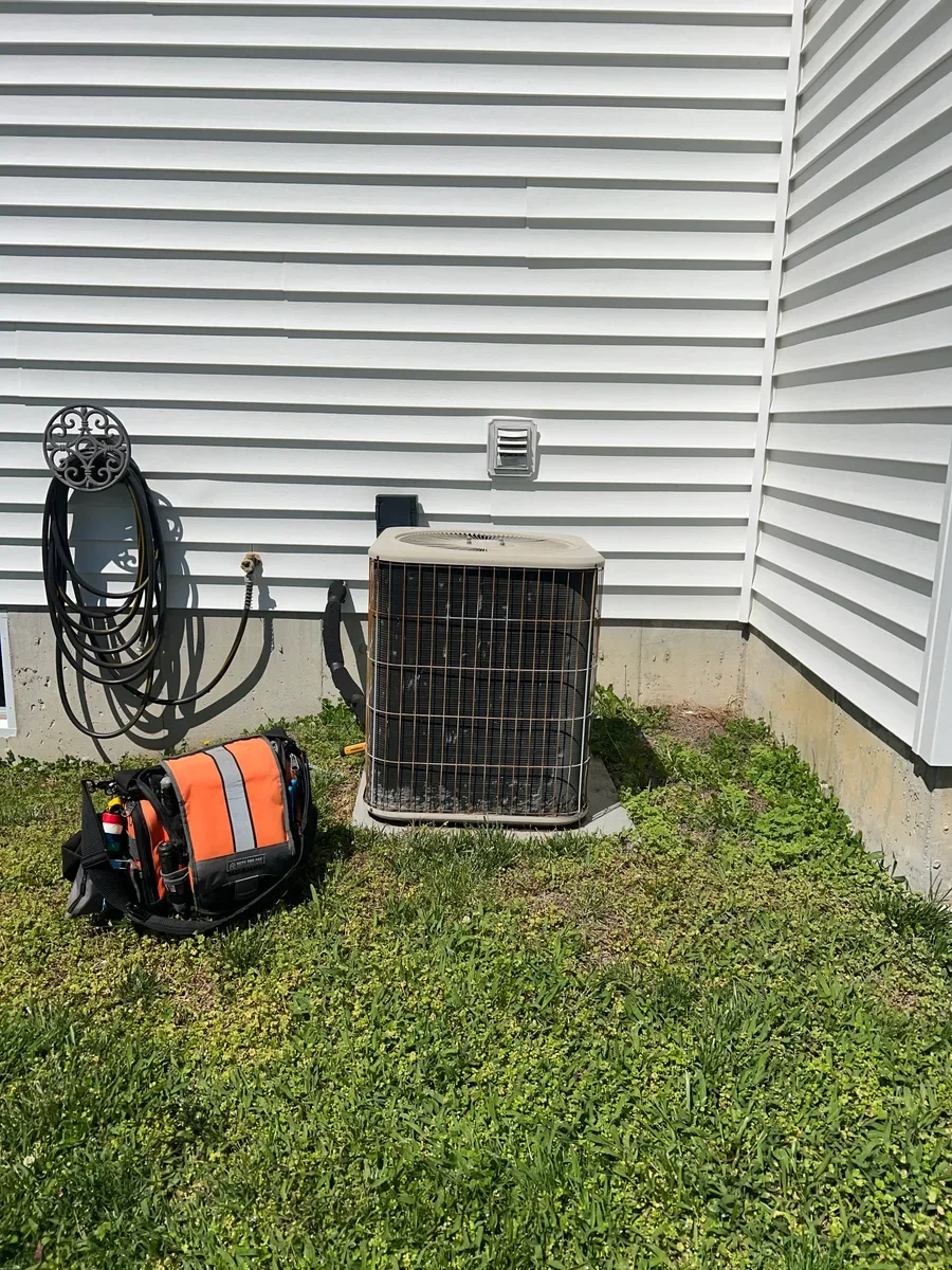 Existing outdoor air conditioner before replacement in a narrow Wentzville side yard.